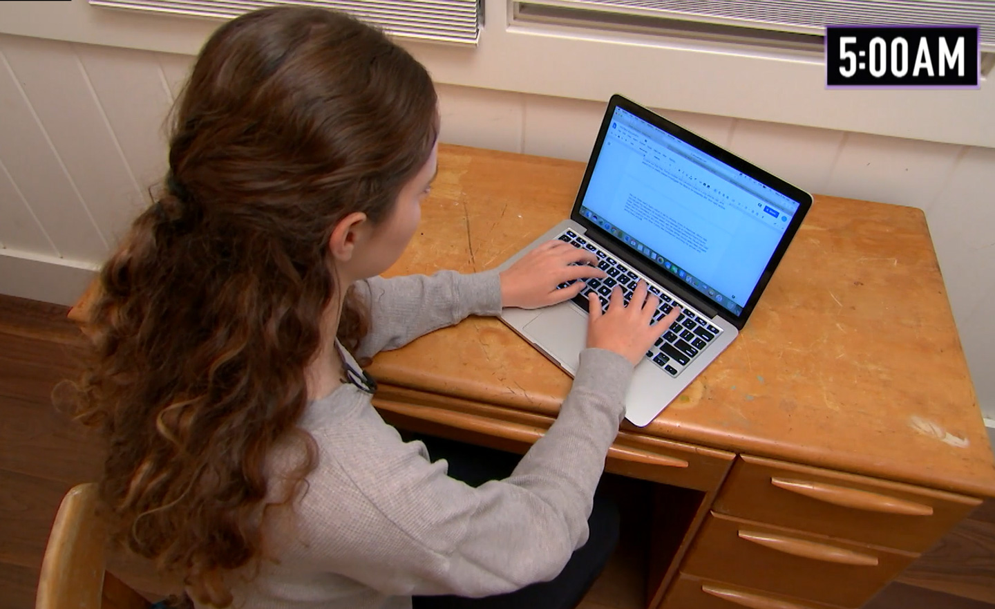 Olivia Seltzer sitting at her laptop computer.