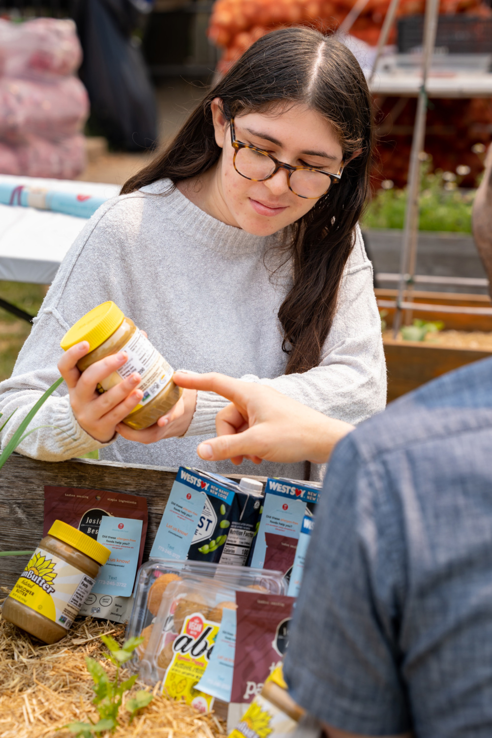 Sydney Hankin points out a food label to a customer.