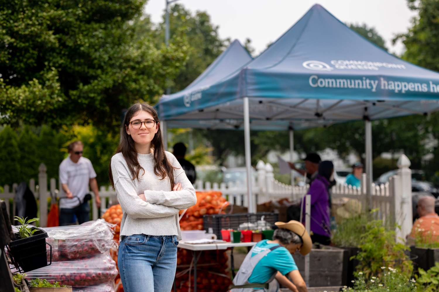 Sydney Hankin poses outside a booth at a farmer's market.