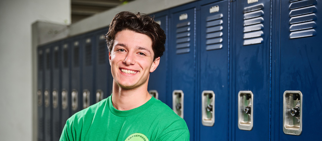 Mason Arditi poses in front of school lockers.