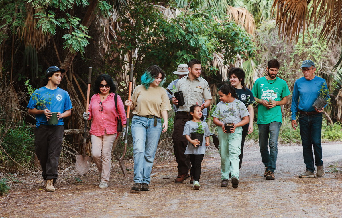 Catarina walks through the wildlife refuge with a group of volunteers.