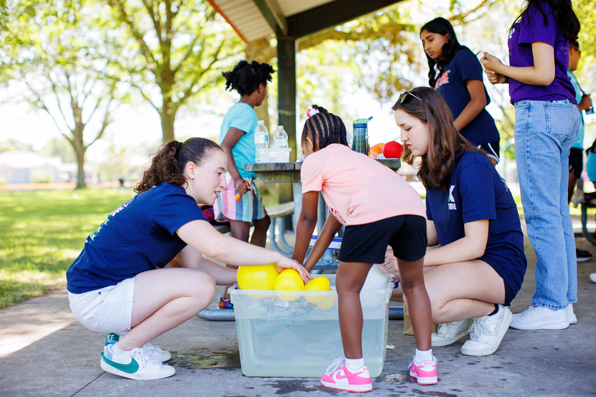 Sophia Libman assists a child with an activity.