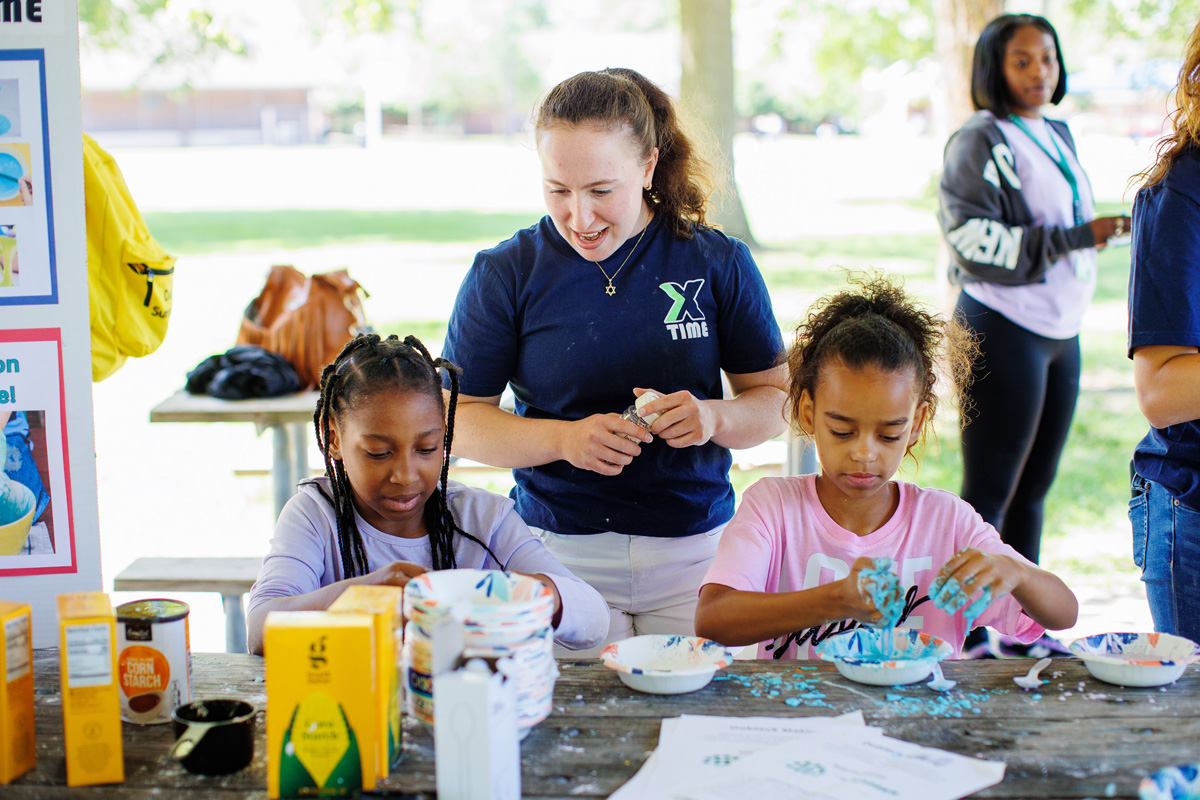 Sophia Libman oversees two children with an art activity.